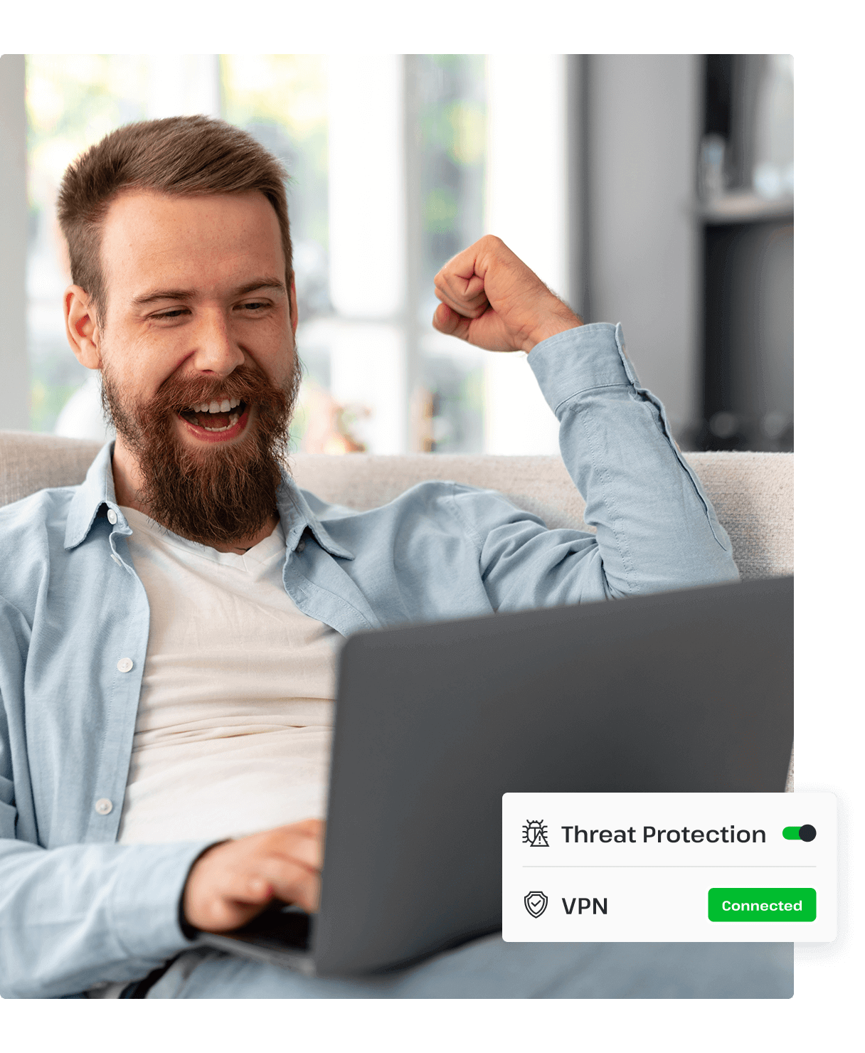 A man raises a fist in triumph while using his laptop, which is connected to UsenetServer’s VPN, which offers premium threat protection to secure his personal data.