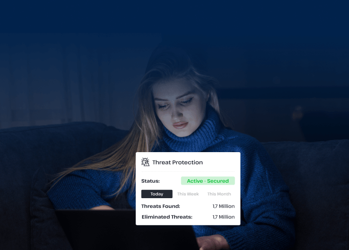 A woman sits on a sofa using a laptop to explore Usenet with UsenetServer’s advanced threat protection settings, keeping her online activity safe from risks.